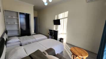 Desk, laptop workspace, blackout drapes, iron/ironing board