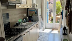 A modern kitchen with a gas stove, built-in oven, and a refrigerator. - "La Victoire" Fisherman's house at an alleyway from the sea... (Saint-Aubin-sur-Mer)