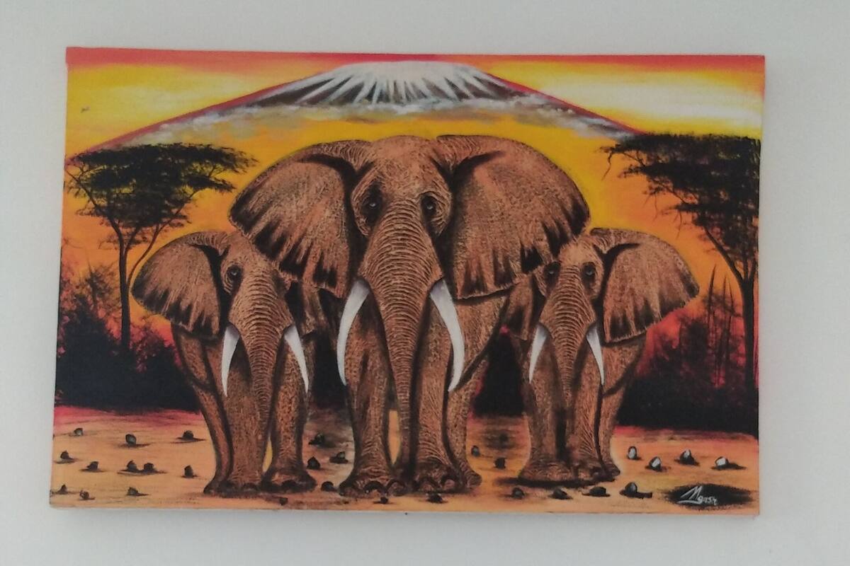 Una pintura de elefantes con un atardecer de fondo.