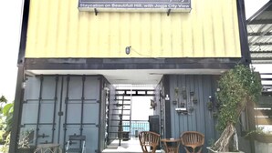 A building with a sign reading "CONTANA Glamping Staycation on Beautiful Hill, with Jogja City View." - Contana By Travelink (Srimulyo)
