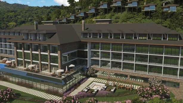 A modern hotel with a spacious outdoor area, multiple balconies, and lush landscaping. - Hotel Boutique Gran Paradiso Resort (Campos do Jordão)