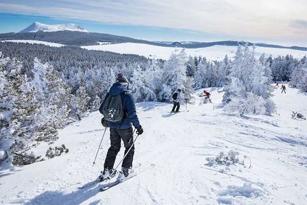 A snowy landscape with skiers.