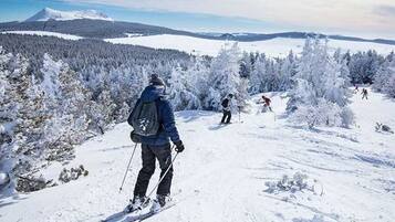 A snowy landscape with skiers.