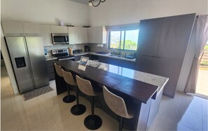 Enjoy cooking in this well-equipped kitchen with a central island and bar stools.