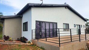 Guests can enjoy a spacious balcony with a railing, large windows with frosted glass, and a modern design.