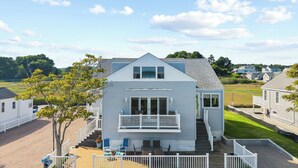 A two-story house with a balcony, a front porch, and a small deck area. - Seaside Sanctuary steps from Long Island Sound (Westbrook)