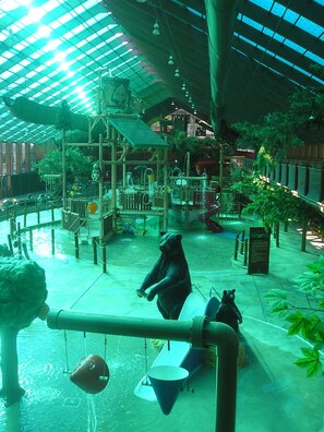 An indoor play area with a water feature, a bear statue, and a green canopy. - 4-BDR, 4-BA MTN-TOP GATLINBRG CHRISTMAS CONDO RETREAT, INDOOR WATERPRK, FIREPITS (Gatlinburg)
