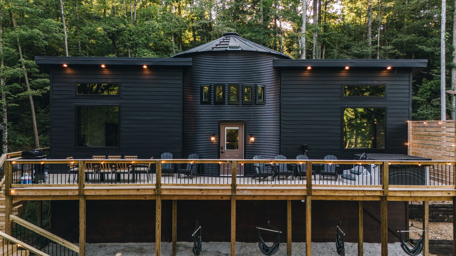 Fall light filters through the trees as string lights line the deck. The Still`s silo profile is unmistakable the moment you pull up the drive.