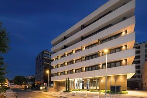 A multi-story hotel with a modern design, featuring a flat facade and evenly spaced windows. - Boutique Hotel Porto (Dubrovnik)