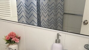 A bathroom with a toilet, sink, and a trash can. - The most comfortable apartment in San Fernando (San Fernando)