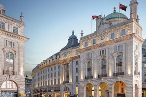 A historic building with classical architecture, featuring large windows and arched doorways. - Hotel Cafe Royal (London)