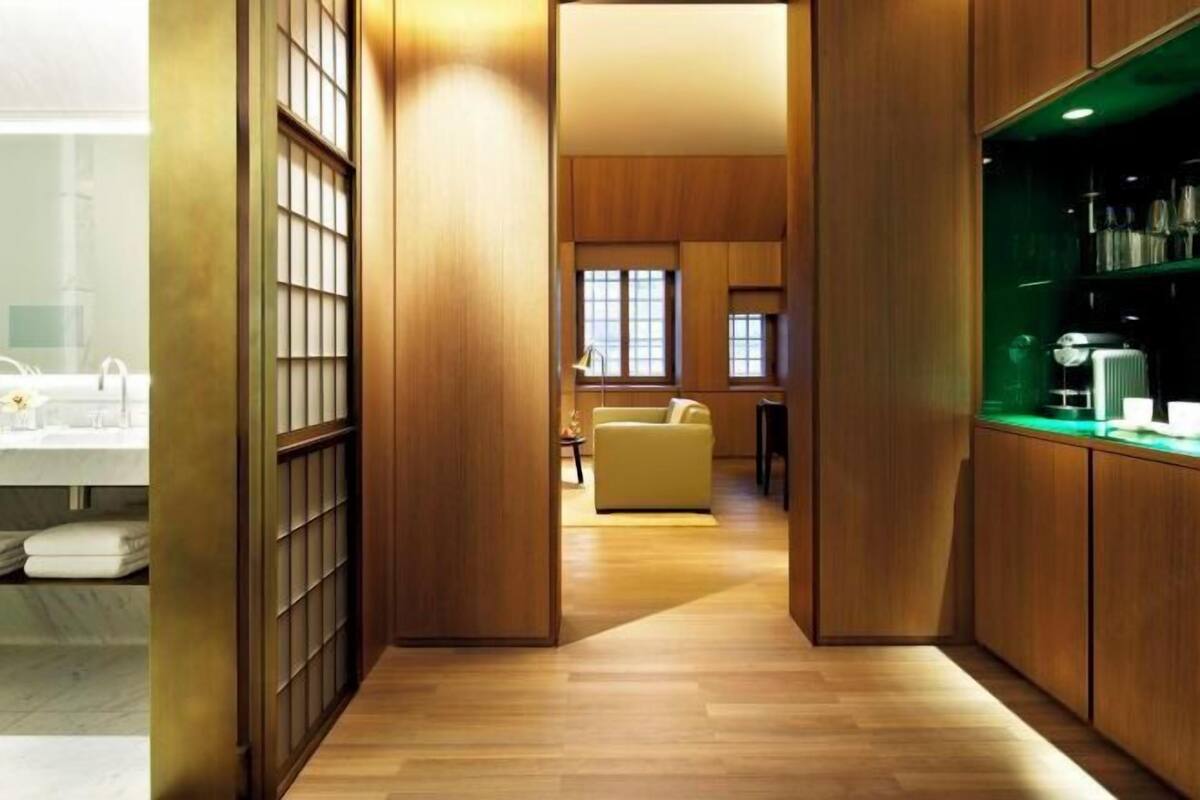 A modern interior with wooden paneling, a kitchen area, and a seating space.