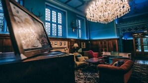 A room with a chandelier, wooden furniture, and a patterned carpet. - Cbh Ruthin Castle Hotel and Spa (Ruthin)