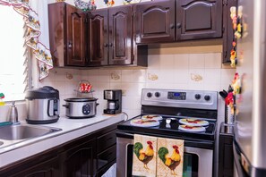 Fridge, microwave, stovetop, coffee/tea maker