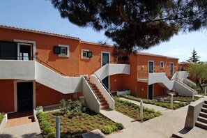 Staircases lead to various levels in this contemporary building surrounded by a lush landscaped area.