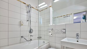 Une salle de bain moderne avec une baignoire, des toilettes et un lavabo.