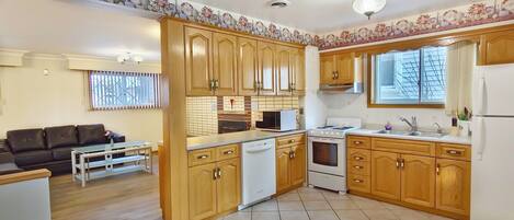 Functional kitchen with modern appliances and dining area.