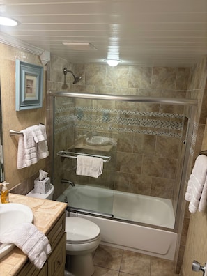 Shower, hair dryer, towels, toilet paper