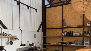 A kitchen with a wooden countertop, a gas stove, and a microwave.