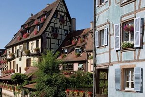 A row of traditional European-style buildings with multiple stories, featuring steeply pitched roofs and exposed timber framing. - Hôtel Le Maréchal (Colmar)