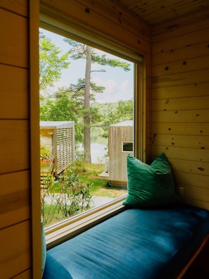 A wooden cabin with a window seat overlooking a pond and trees. - Prospect Berkshires (Egremont)