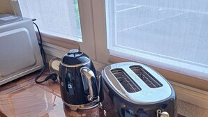 A kitchen counter with a coffee maker and a toaster.