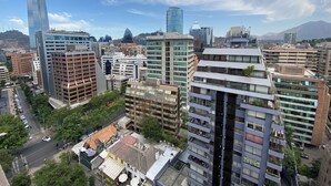 A cityscape with a variety of buildings, including modern high-rises and older structures. - The best location in Santiago, in the heart of the golf neighborhood, MUT, Costanera Ctr. (Las Condes)