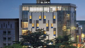 A modern hotel building with a prominent sign reading "HOTEL BLOKM". - Hotel 88 Blok M Jakarta by WH (Jakarta)