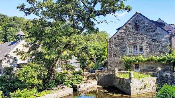 A stone building with a small bridge over a canal, surrounded by greenery. - Villa Colette by Interhome (Plouhinec Morbihan)