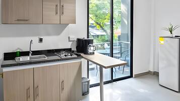 Fridge, microwave, coffee/tea maker, cookware/dishes/utensils