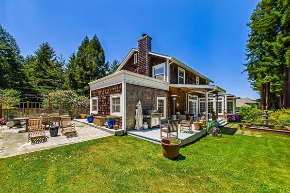 A two-story house with a patio, outdoor seating, and a garden. - Quiet, luxe, near trails & town (Arcata)
