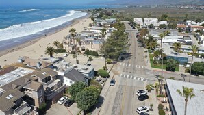 A coastal residential area with houses, a beach, and a road. - 1 Bed Beach Condo #131 1 Bedroom Condo by Sunset Shores Condominiums (Carpinteria)