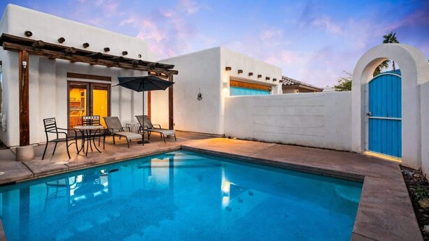 A swimming pool with lounge chairs and a pergola. - Private Pool Home with Patio | La Quinta Cove (La Quinta)