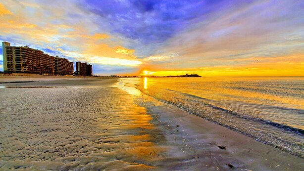 A beach with a hotel in the background. - BeachBumCondos (Puerto Penasco)