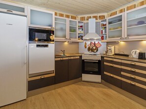 A kitchen with a Bosch refrigerator, microwave, oven, and stove.
