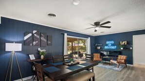 A dining area with a dark wooden table, chairs, and a ceiling fan. - NEW - Moody BBQ Retreat w/Covered Patio (Jackson)