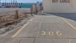 A parking lot with a sign reading "KEY LARGO" and a number "306" painted on the ground. - Beach Block steps to sand and many more attractions making this the perfect spot (Wildwood)