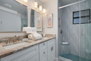 Shower, hair dryer, towels, shampoo