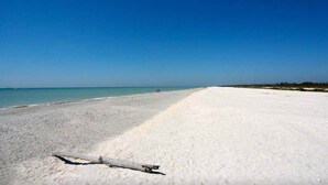 A wide, sandy beach with a clear blue sky. - Blind Pass C106  | Upgraded Ground Floor Residence at Blind Pass | Steps to Pool (Sanibel)