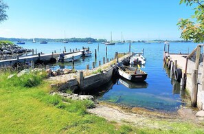 Enjoy a serene waterfront setting with a dock area and boats moored nearby.