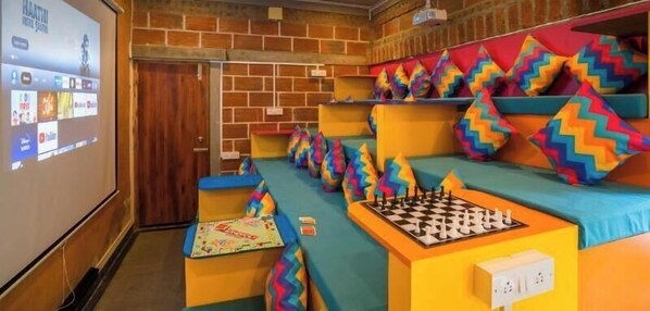 A theatre with colorful seating and a chessboard. - goSTOPS Pondicherry Near Auroville (Auroville)