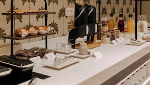 A breakfast buffet with various food items and kitchen appliances. - Hotel PAX Atocha (Madrid)