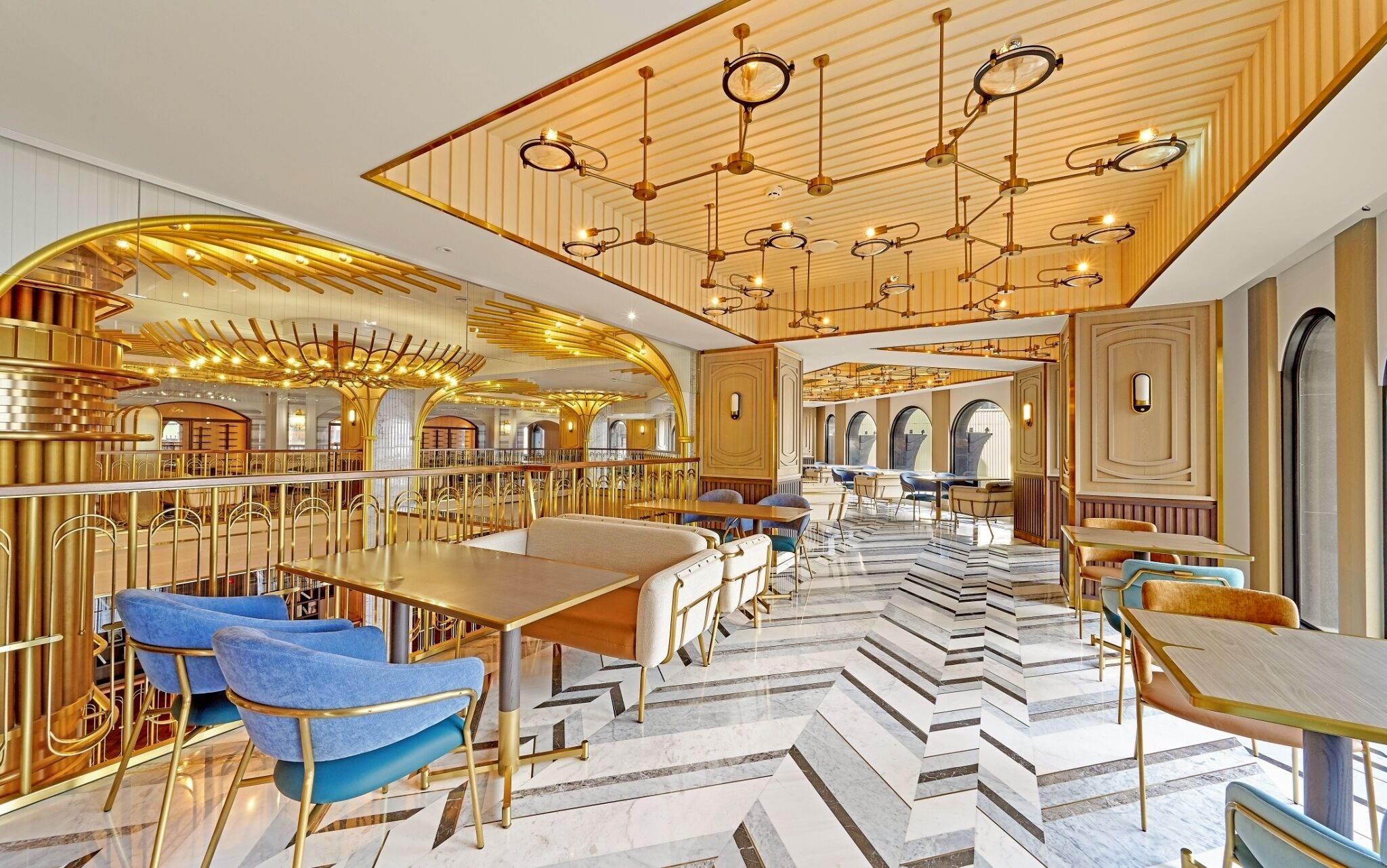 A luxurious hotel lobby with high-end furnishings, a grand chandelier, and a modern design.