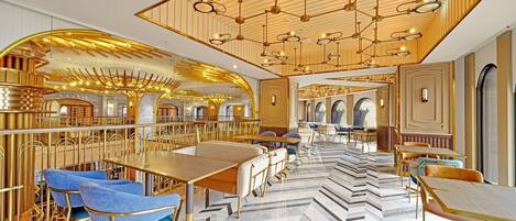 A luxurious hotel lobby with high-end furnishings, a grand chandelier, and a modern design.