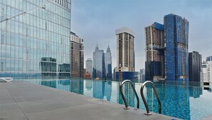 A modern hotel pool with a city skyline view, including high-rise buildings and a clear sky. - Dorsett Kuala Lumpur by Five Senses (Kuala Lumpur)