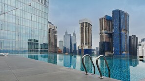 A modern hotel pool with a city skyline view, including high-rise buildings and a clear sky. - Dorsett Kuala Lumpur by Five Senses (Kuala Lumpur)