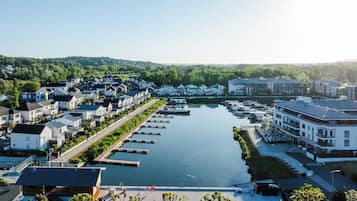 A riverside residential area with modern houses, a marina, and a restaurant.