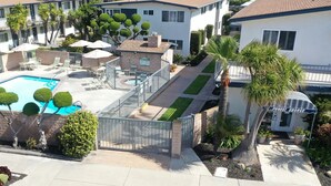 A residential property with a swimming pool, a covered patio, and a well-maintained garden. - Beach Condo W/private Patio #133 1 Bedroom Condo by RedAwning (Carpinteria)