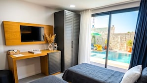 A hotel room with two beds, a desk, a TV, and a view of a swimming pool. - Kiva Alaçatı Hotel By Amarillo  (Cesme)