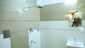 A bathroom with a shower, a sink, and a mirror. - 4 U BUSINESS CLASS (Chennai)